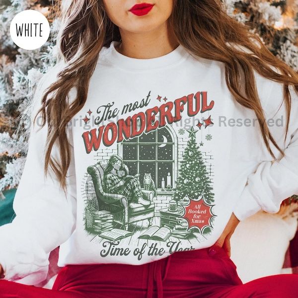 a white woman wearing a white crewneck sweater with text that reads "The Most Wonderful Time of the Year" arranged around two-toned graphic of a woman reading in an armchair by a Christmas tree