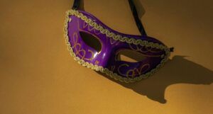 purple and gold mask against a gold background