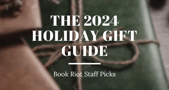 blurred image of a gift wrapped in green paper with a twine bow. Text over the image reads "The 2024 Holidat Gift Guide, Book Riot Staff Picks"