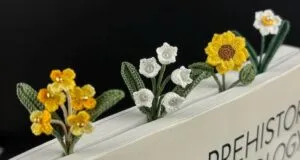 micro crochet flower bookmarks sticking out of a book