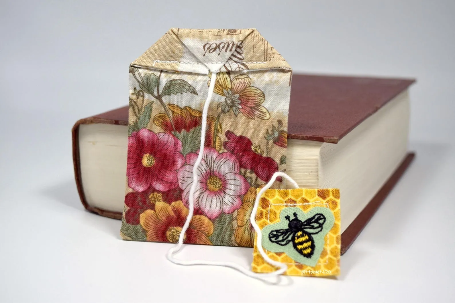 a floral fabric bookmark in the shape of a tea bag